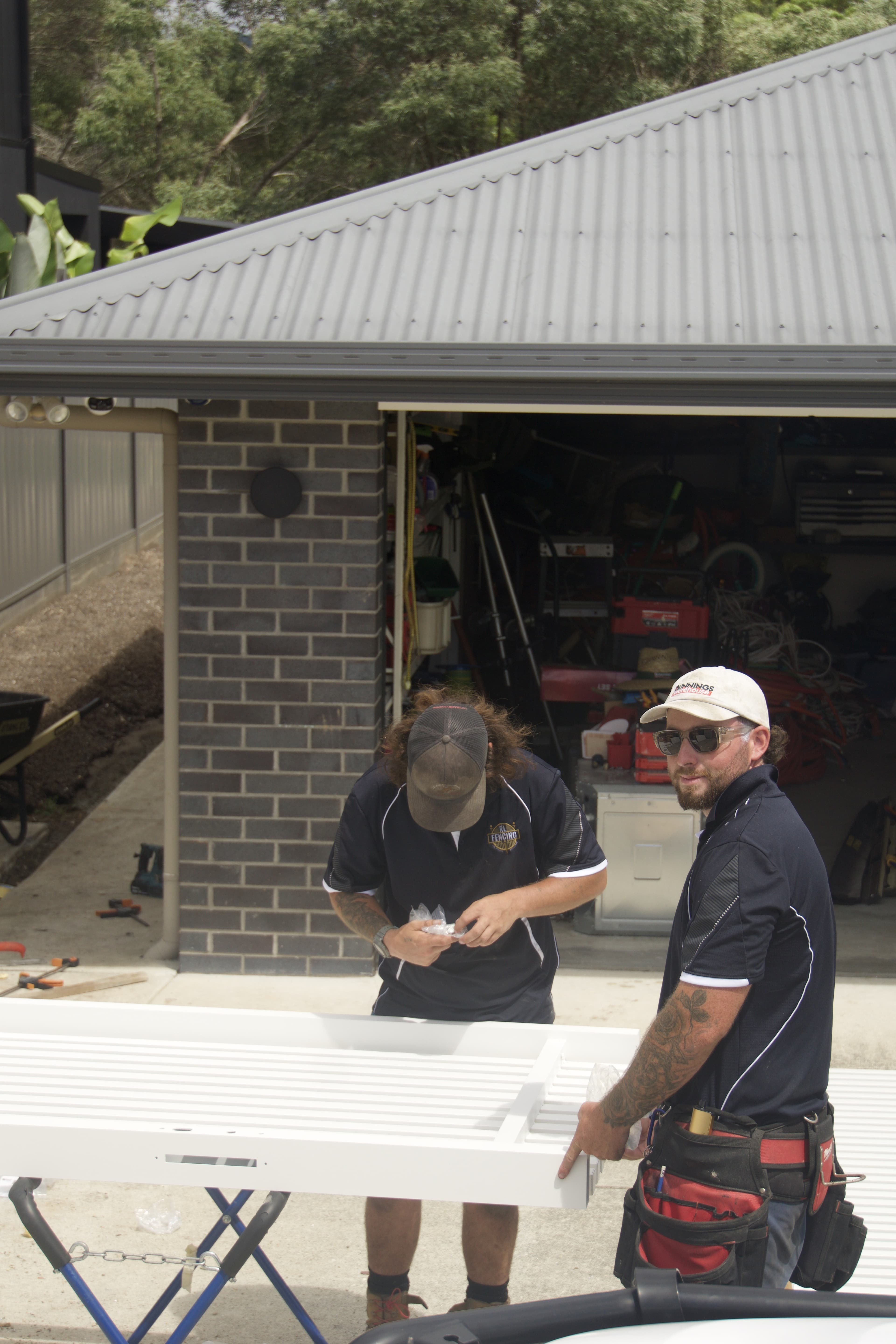 The RL Fencing team preparing a batten gate panel for installation
